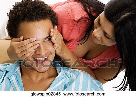 Close-up of a young woman covering the eyes of a young man View Large Photo Image Stock Photography - Close-up of a young woman covering the eyes of a young man. Fotosearch