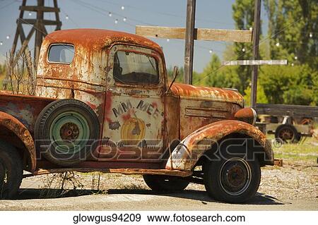 Stock Photo - Close-up of an abandoned pick-up truck parked on a field. Fotosearch