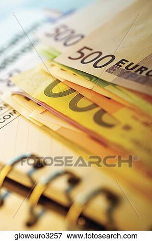 Stock Photo - Close-up of assorted Euro banknotes on a diary. Fotosearch