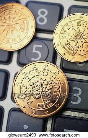 Stock Image - Close-up of Eurocent coins on a calculator. Fotosearch