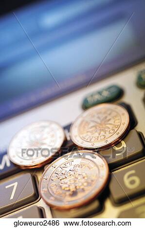 Close-up of Eurocent coins on a calculator View Large Photo Image Stock Photograph - Close-up of Eurocent coins on a calculator. Fotosearch