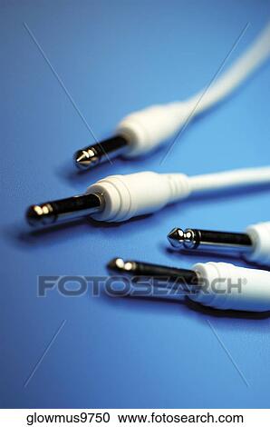 Stock Image - Close-up of four white audio cables. Fotosearch