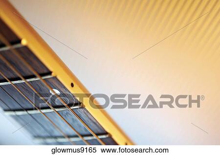 Stock Photography - Close-up of handle and strings of electric guitar. Fotosearch