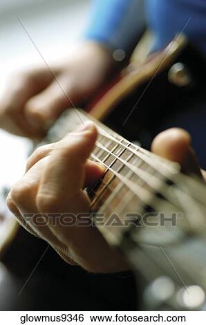 Close-up of man playing acoustic guitar View Large Photo Image Stock Photograph - Close-up of man playing acoustic guitar. Fotosearch