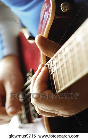 Close-up of man playing acoustic guitar View Large Photo Image Stock Photography - Close-up of man playing acoustic guitar. Fotosearch
