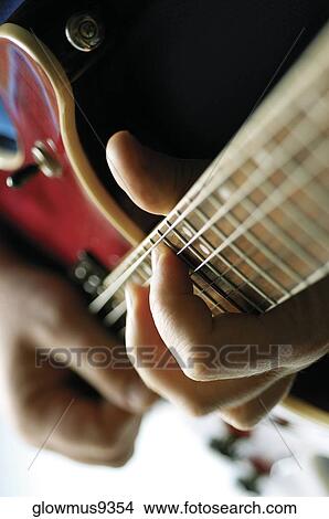 Close-up of man playing electric guitar View Large Photo Image Picture - Close-up of man playing electric guitar. Fotosearch