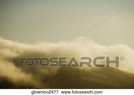 Clouds rolling over a hill range View Large Photo Image Stock Photo - Clouds rolling over a hill range. Fotosearch