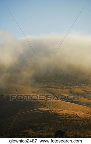 Clouds rolling over a hill range View Large Photo Image Stock Photo - Clouds rolling over a hill range. Fotosearch