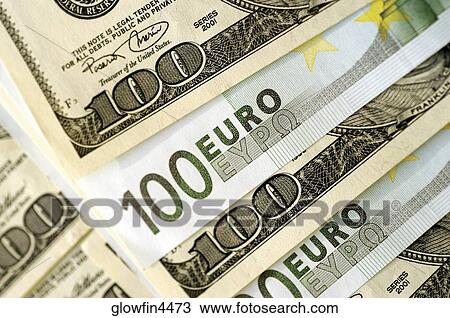 Stock Image - Euro 100 bank notes and United States one hundred dollar bills, close-up. Fotosearch