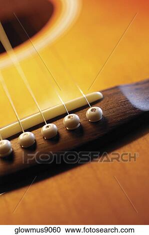 Stock Image - Extreme close-up of guitar bridge. Fotosearch