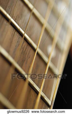 Extreme close-up of guitar frets and strings View Large Photo Image Stock Photograph - Extreme close-up of guitar frets and strings. Fotosearch