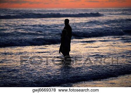 Father and his daughter standing in the water at the beach View Large Photo Image Stock Photo - Father and his daughter standing in the water at the beach. Fotosearch