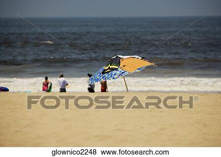 Stock Photo - Group of people on the beach. Fotosearch