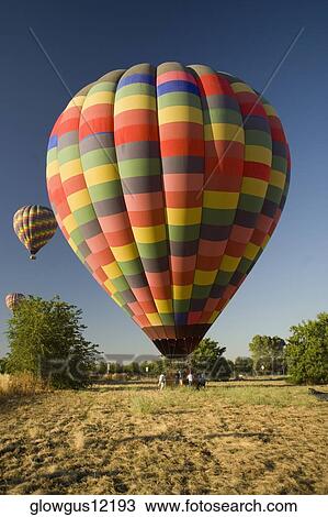 Group of people standing near a hot air balloon View Large Photo Image Stock Image - Group of people standing near a hot air balloon. Fotosearch