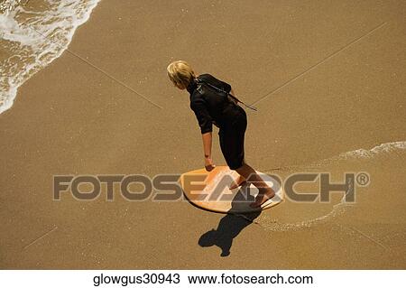 High angle view of a boogie boarder on the beach View Large Photo Image Stock Image - High angle view of a boogie boarder on the beach. Fotosearch