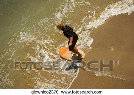 High angle view of a boogie boarder on the beach View Large Photo Image Stock Image - High angle view of a boogie boarder on the beach. Fotosearch