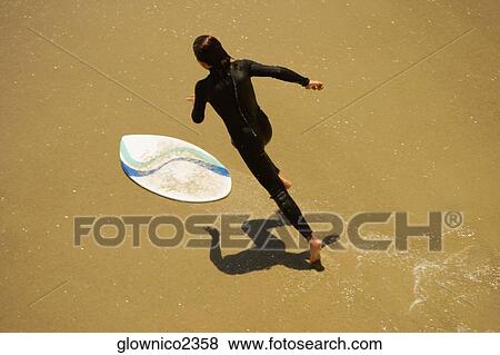 High angle view of a boogie boarder on the beach View Large Photo Image Stock Photo - High angle view of a boogie boarder on the beach. Fotosearch
