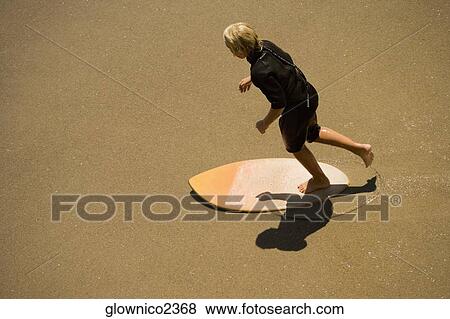 High angle view of a boogie boarder on the beach View Large Photo Image Stock Photo - High angle view of a boogie boarder on the beach. Fotosearch