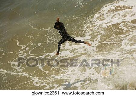 High angle view of a surfer leaping into the sea View Large Photo Image Stock Image - High angle view of a surfer leaping into the sea. Fotosearch