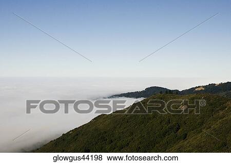 High angle view of clouds around a hill range View Large Photo Image Stock Photo - High angle view of clouds around a hill range. Fotosearch