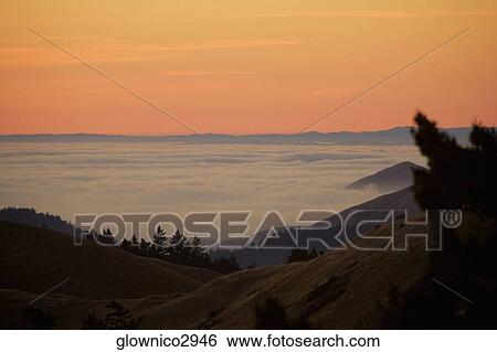 High angle view of clouds around a hill View Large Photo Image Stock Photograph - High angle view of clouds around a hill. Fotosearch
