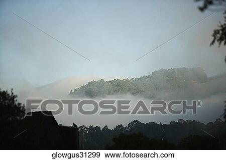 Stock Photo - High angle view of fog on a hill range. Fotosearch
