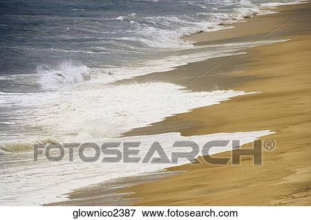 High angle view of the surf flowing on to a beach View Large Photo Image Stock Photo - High angle view of the surf flowing on to a beach. Fotosearch