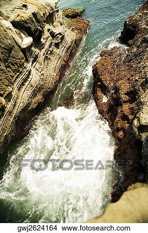 High angle view of water flowing over a rock formation, La Jolla Reefs, San Diego Bay, California, USA View Large Photo Image Picture - High angle view of water flowing over a rock formation, La Jolla Reefs, San Diego Bay, California, USA. Fotosearch