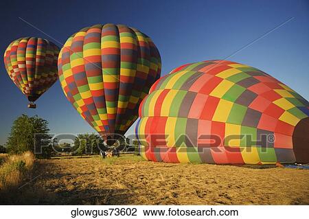 Stock Image - Hot air balloons preparing to take off. Fotosearch