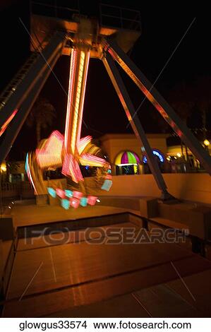 Lights glowing on a carnival ride at night, California, USA View Large Photo Image Picture - Lights glowing on a carnival ride at night, California, USA. Fotosearch
