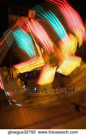 Lights glowing on a carnival ride at night, California, USA View Large Photo Image Stock Image - Lights glowing on a carnival ride at night, California, USA. Fotosearch