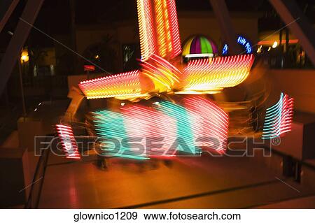 Lights glowing on a carnival ride at night, California, USA View Large Photo Image Stock Photo - Lights glowing on a carnival ride at night, California, USA. Fotosearch