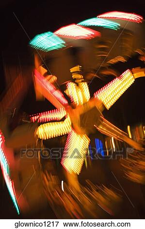 Lights glowing on a carnival ride at night, California, USA View Large Photo Image Stock Photo - Lights glowing on a carnival ride at night, California, USA. Fotosearch