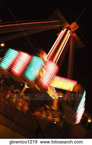 Stock Photo - Lights glowing on a carnival ride at night, California, USA. Fotosearch