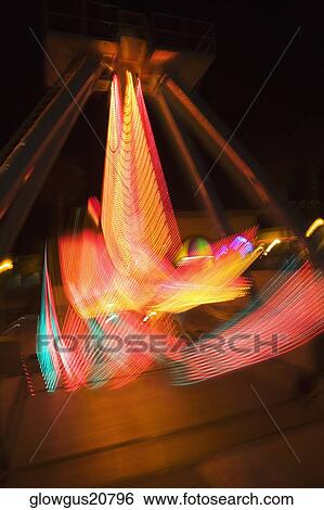 Lights glowing on a carnival ride at night, California, USA View Large Photo Image Stock Photograph - Lights glowing on a carnival ride at night, California, USA. Fotosearch