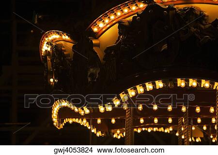 Picture - Lights on a carousel in an amusement park at night, San Diego, California, USA. Fotosearch