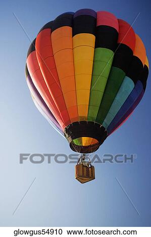 Low angle view of a hot air balloon flying in the sky View Large Photo Image Stock Image - Low angle view of a hot air balloon flying in the sky. Fotosearch