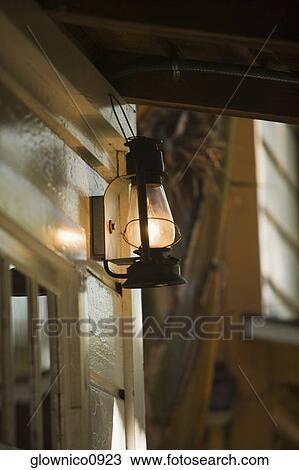Stock Image - Low angle view of a lantern on a porch. Fotosearch