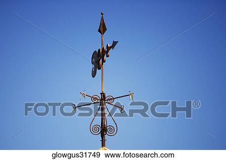 Low angle view of a weather vane on a rooftop View Large Photo Image Stock Photo - Low angle view of a weather vane on a rooftop. Fotosearch