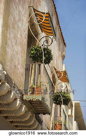 Low angle view of balconies on a stucco building View Large Photo Image Stock Photograph - Low angle view of balconies on a stucco building. Fotosearch