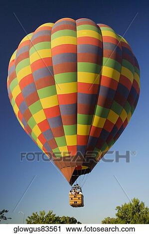 Low angle view of hot air balloon flying in the sky View Large Photo Image Stock Image - Low angle view of hot air balloon flying in the sky. Fotosearch