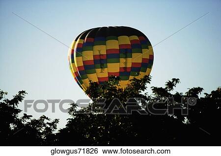 Low angle view of hot air balloon flying in the sky View Large Photo Image Stock Photograph - Low angle view of hot air balloon flying in the sky. Fotosearch