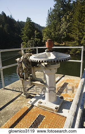 Metal gears on the pier of a lake View Large Photo Image Stock Photo - Metal gears on the pier of a lake. Fotosearch
