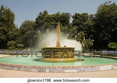Ornate stone fountain spouting water View Large Photo Image Stock Photograph - Ornate stone fountain spouting water. Fotosearch