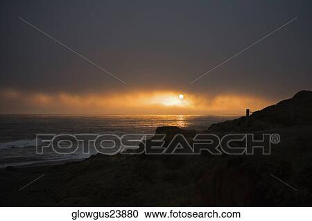 Stock Image - Panoramic view of the beach at dusk, Pacific Ocean. Fotosearch