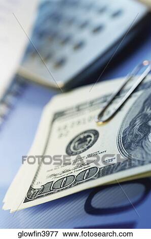 Paper clips, United States one hundred dollar bills, calculator View Large Photo Image Stock Photo - Paper clips, United States one hundred dollar bills, calculator. Fotosearch