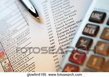 Stock Photography - Pen, calculator and lists of countries with flags next to them, close-up. Fotosearch