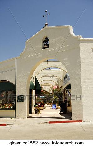 People walking under an arched walkway View Large Photo Image Stock Image - People walking under an arched walkway. Fotosearch
