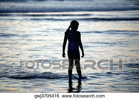 Rear view of a girl standing on the beach, San Diego, California, USA View Large Photo Image Stock Photograph - Rear view of a girl standing on the beach, San Diego, California, USA. Fotosearch