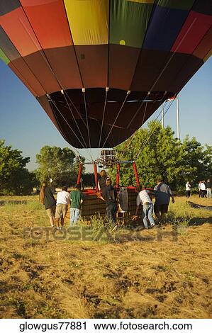 Rear view of people pulling hot air balloon View Large Photo Image Stock Image - Rear view of people pulling hot air balloon. Fotosearch